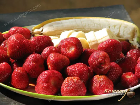 Preparing strawberries and bananas for jam