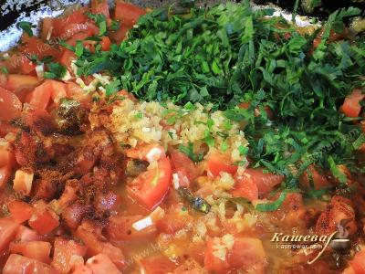 Finely chopped tomatoes, herbs and spices in a pan