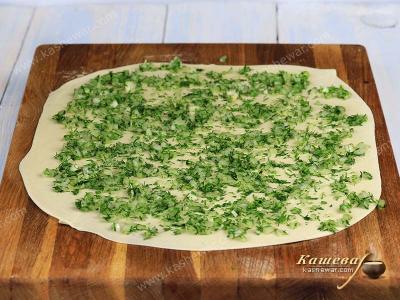 Onions and greens on the dough
