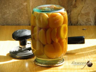Rolling up jars of apricot compote