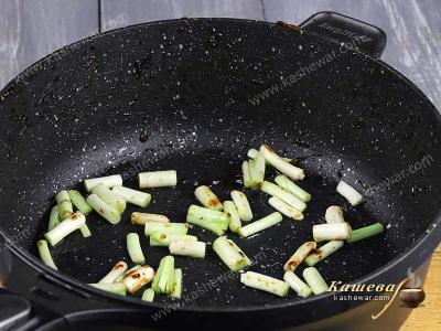 Sliced green onions in a pan