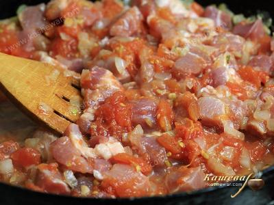 Pork with tomatoes in a pan