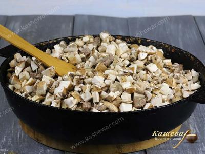 Meat with mushrooms in a pan