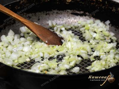 Finely chopped onion in a frying pan with olive oil