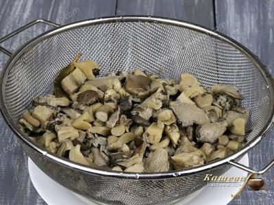 Boiled mushrooms in a sieve